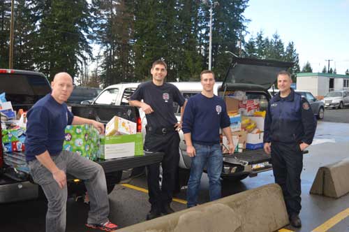 Coquitlam Firefighters pick up food donations for SHARE food bank